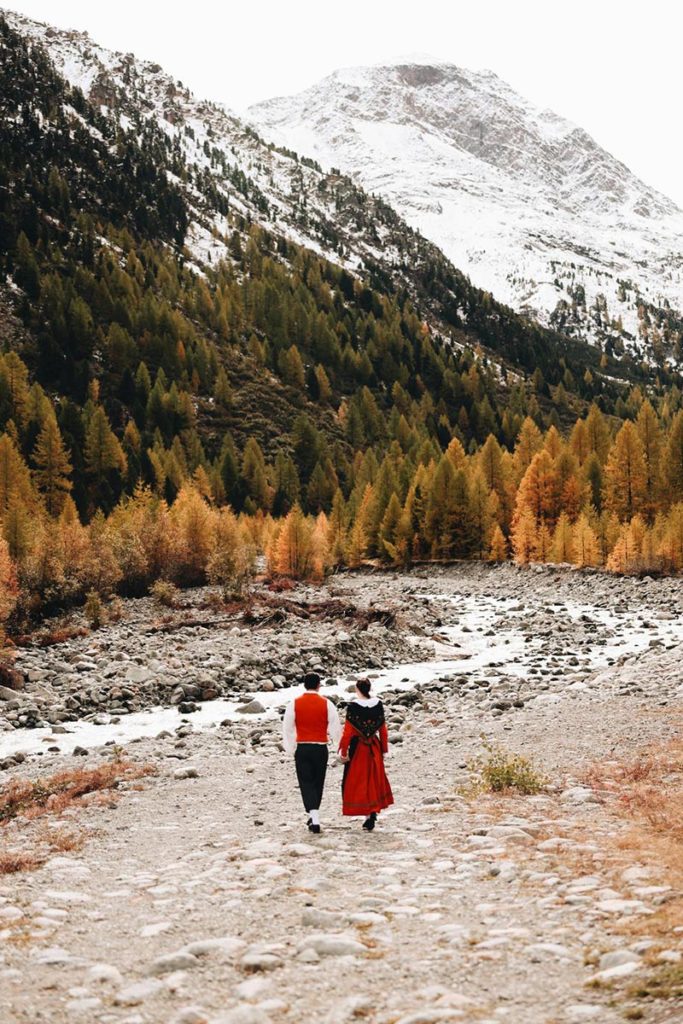 Couple walking in the Engadin Valley in Switzerland in September.