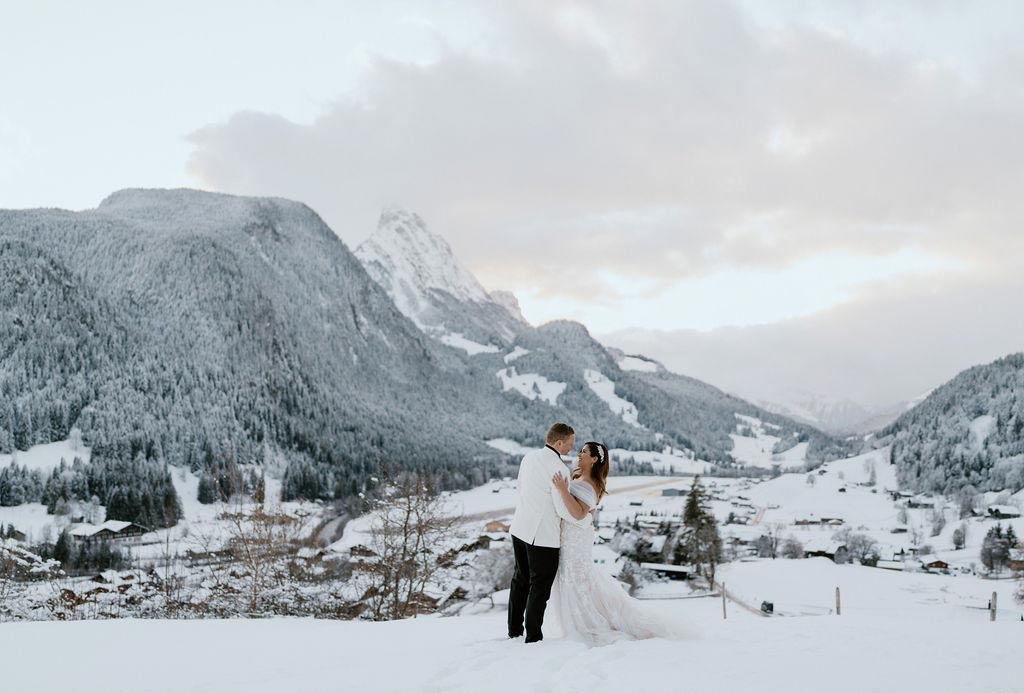 Husband and wife enjoy a private moment after their winter Swiss destination wedding at The Huus Gstaad.