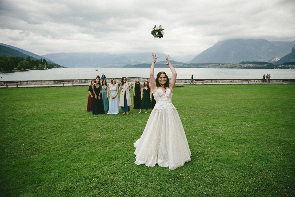 American bride at her destination wedding in Switzerland to her Swiss husband, on the shores or Lake Thun.