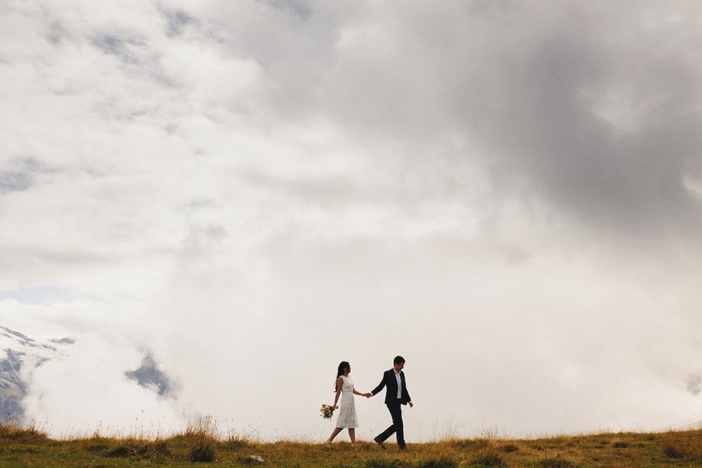 Image of two recently married people with a wide expanse of sky at a small Swiss wedding. Venue was Hotel Vitznauerhof, on the shores of Lake Lucerne.