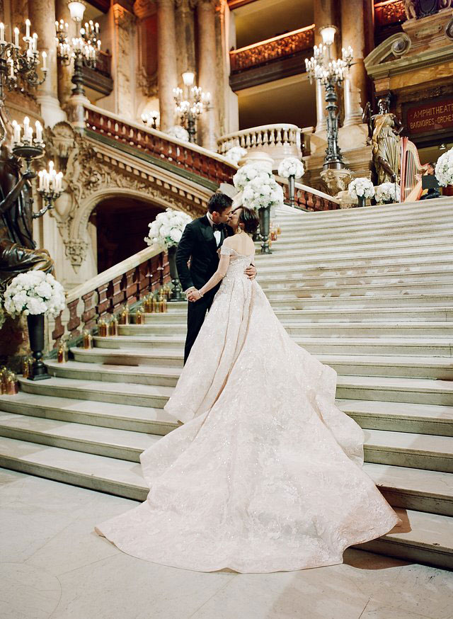 Vicki Bello and Hayden kiss on their wedding day on the steps of the Palais Garnier Paris while being filmed by Story of Your Day