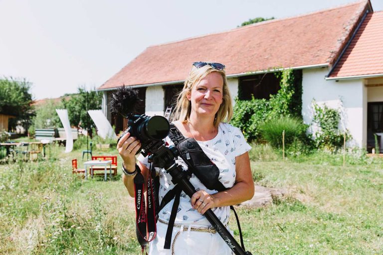 Image of Emma Wilson, Wedding videographer on a shoot holding camera