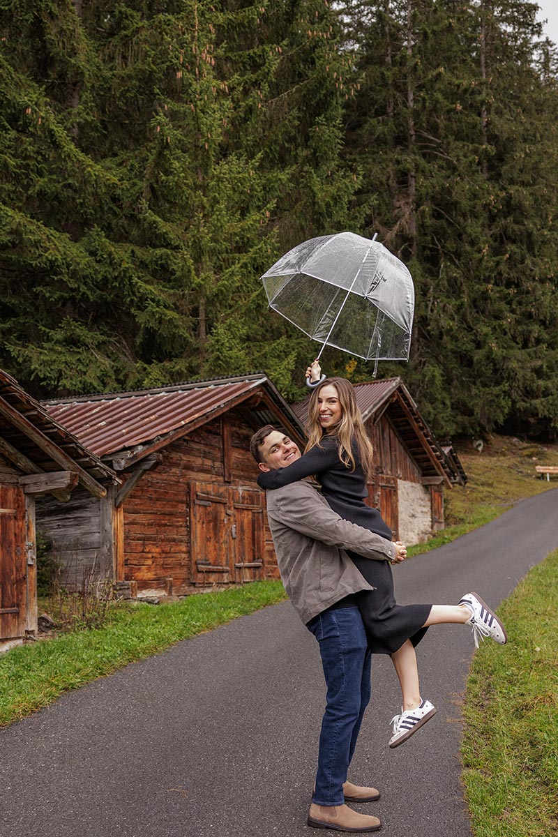 A couple jump in the air after getting engaged in Switzerland